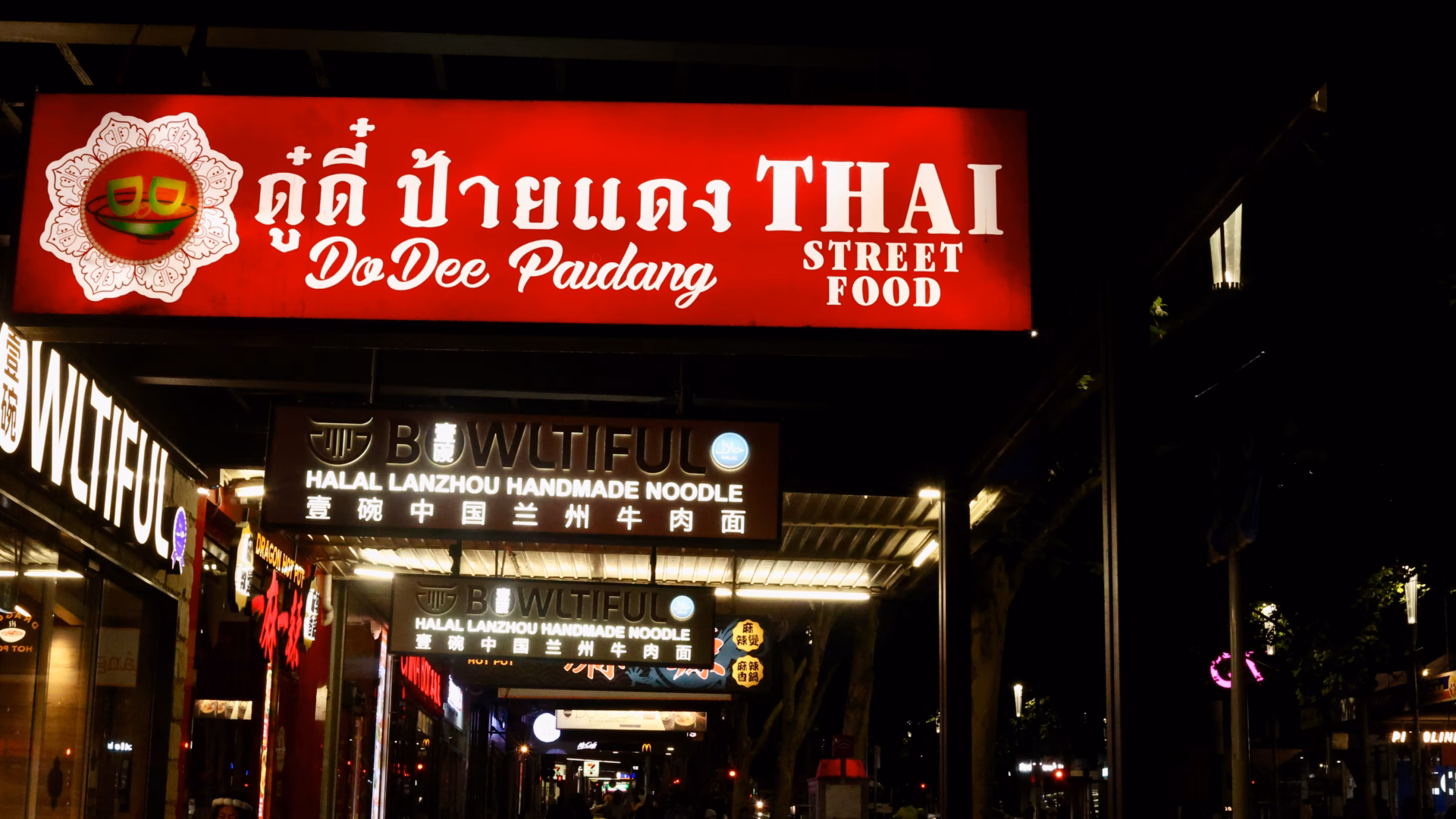 Do Dee Paidang illuminated neon pink script sign against dark background Melbourne CBD