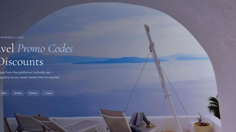 Santorini caldera view through a white arch with sun loungers and the blue Aegean sea