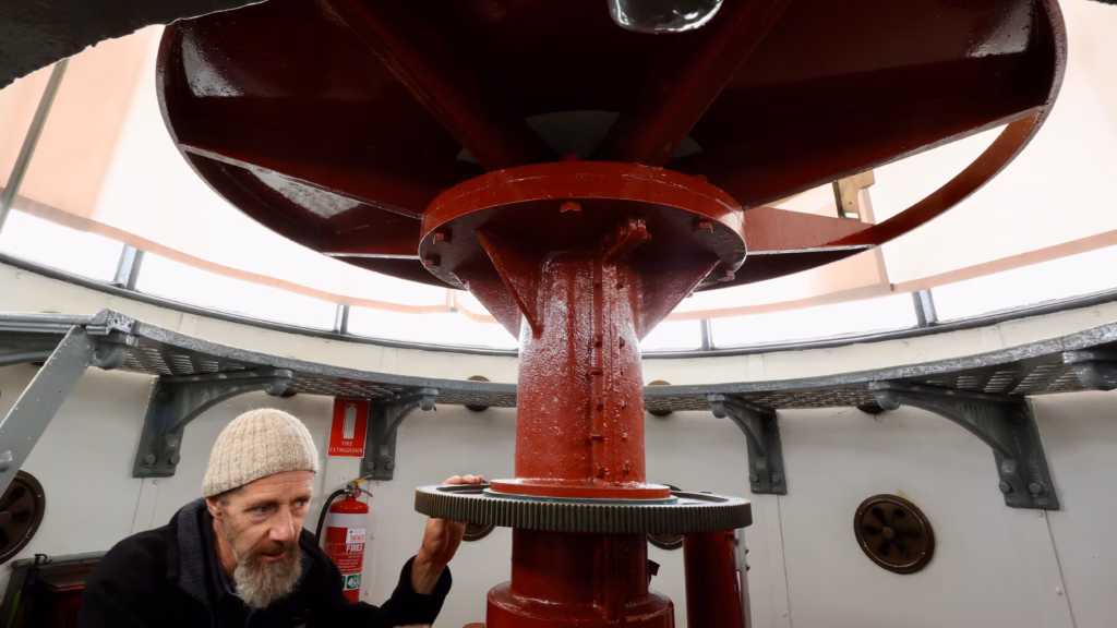 Guide inside the lantern room of Cape Bruny Lighthouse on a Bruny Island tour