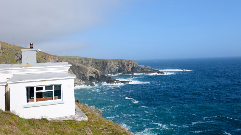White Mizen Head Signal Station building with the cliff coast stretching away behind it