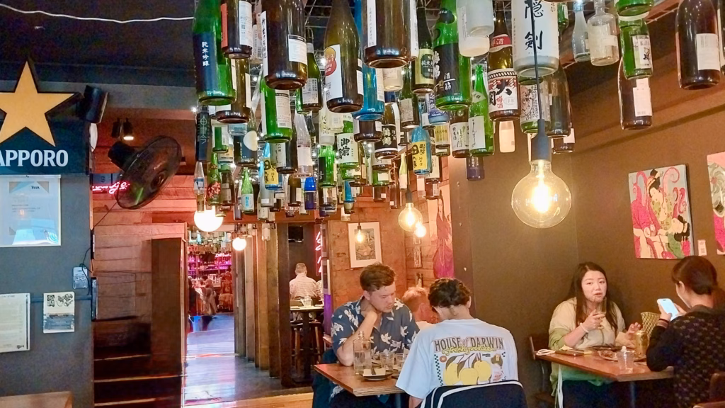 Interior of Bar Wa Izakaya on Elizabeth Street, Hobart, with sake bottles hanging from the ceiling