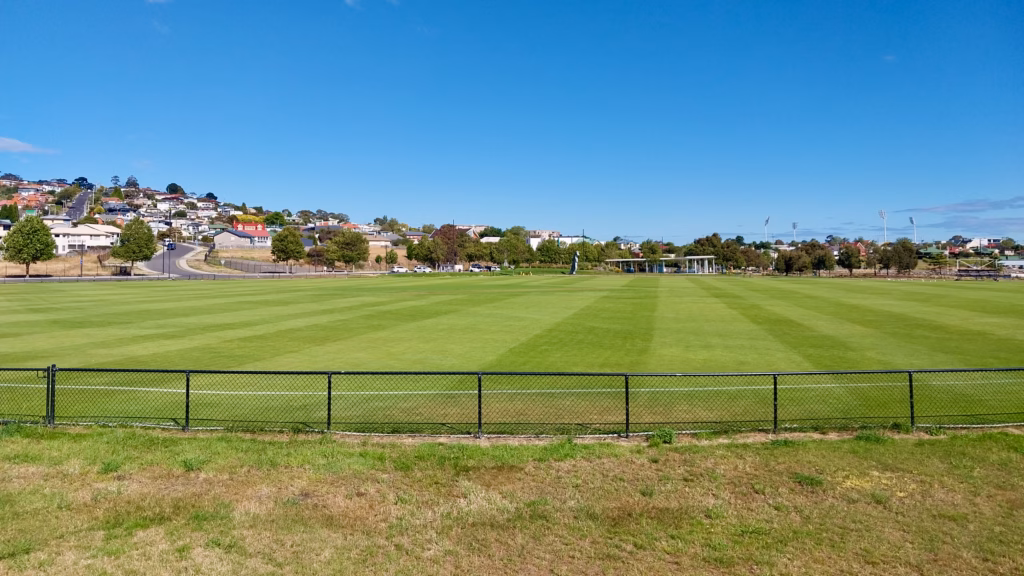 Community cricket ground in Bellerive with Blundstone Arena floodlights on the horizon