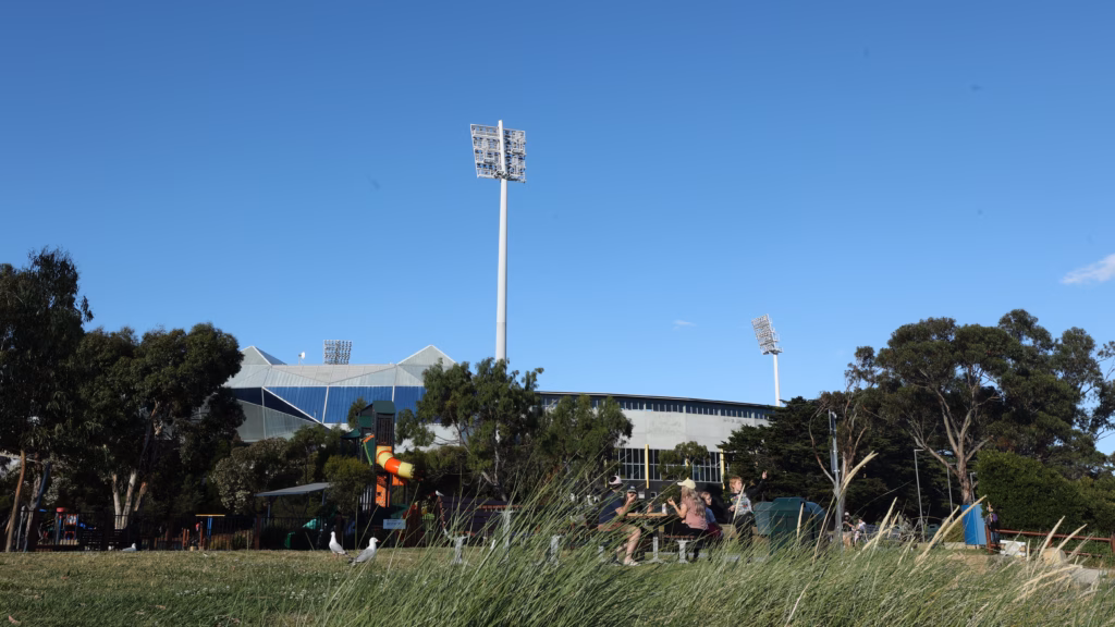 Bellerive Beach Park playground with Blundstone Arena and floodlight pylons behind
