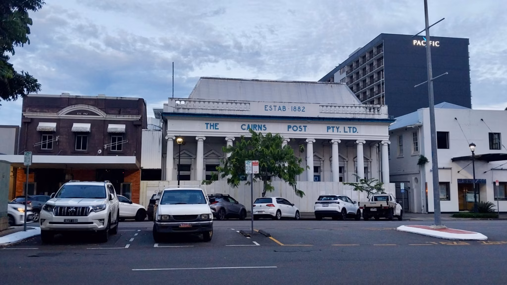 Historic Cairns Post building 1882 at dusk on walk into Cairns CBD