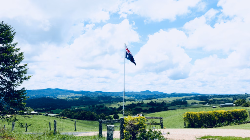 Australian flag flying at Crawford's Lookout with green Tablelands hills behind