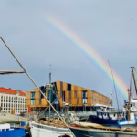 A rainbow arcing over Hobart's waterfront fishing boats after a rain shower