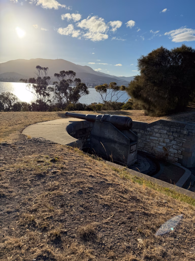 Cannon at Kangaroo Bluff Battery Bellerive with Mt Wellington and the Derwent River silhouetted against the setting sun