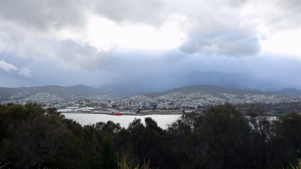 Hobart CBD and Macquarie Wharf under heavy cloud from Rosny Hill Lookout with Mt Wellington shrouded