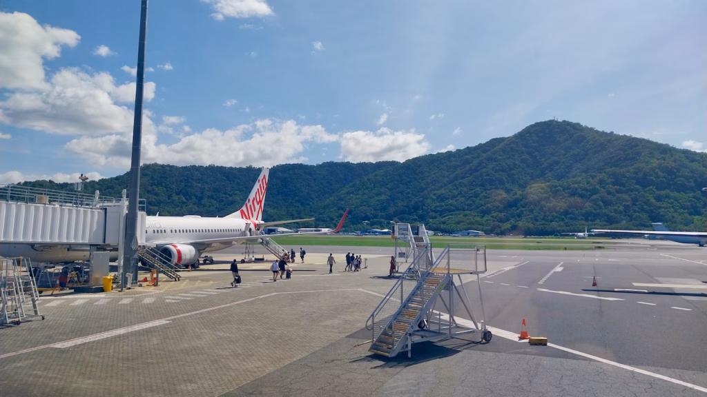 Virgin Australia Boeing 737 boarding at Cairns Airport with passengers walking to the aircraft
