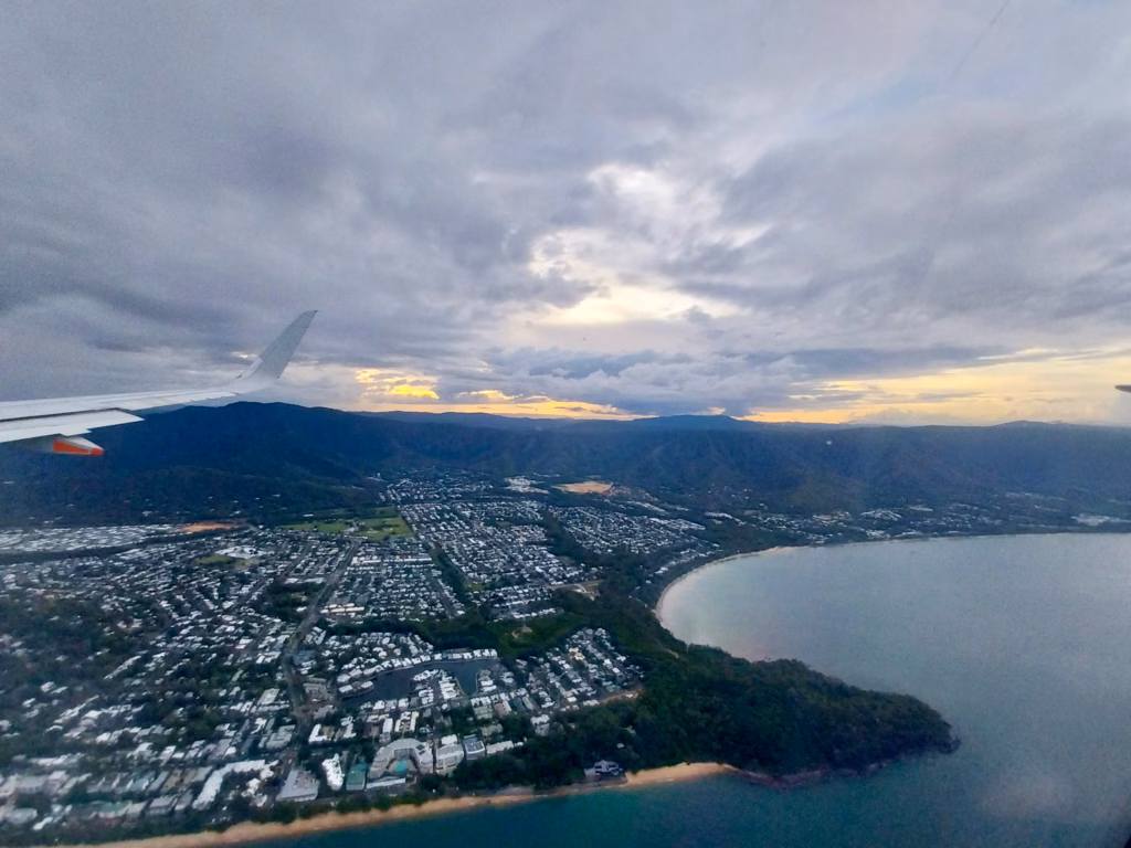 Aerial view of a coastal headland and marina at dusk