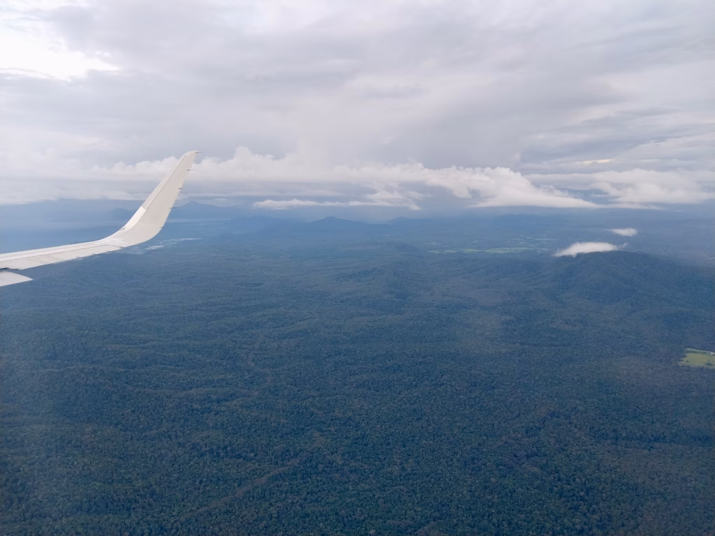 Hazy aerial view with a distant coastline visible on the horizon