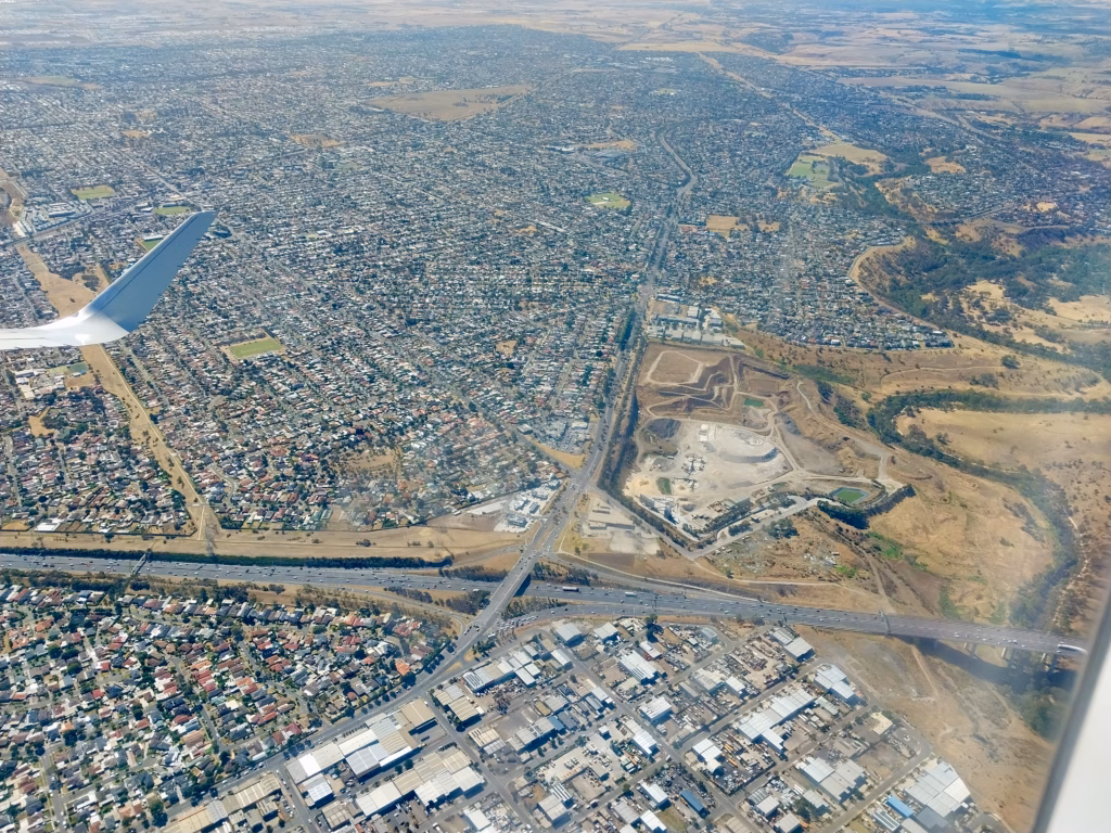 Aerial view of a major highway interchange and industrial estate in Melbourne's outer suburbs
