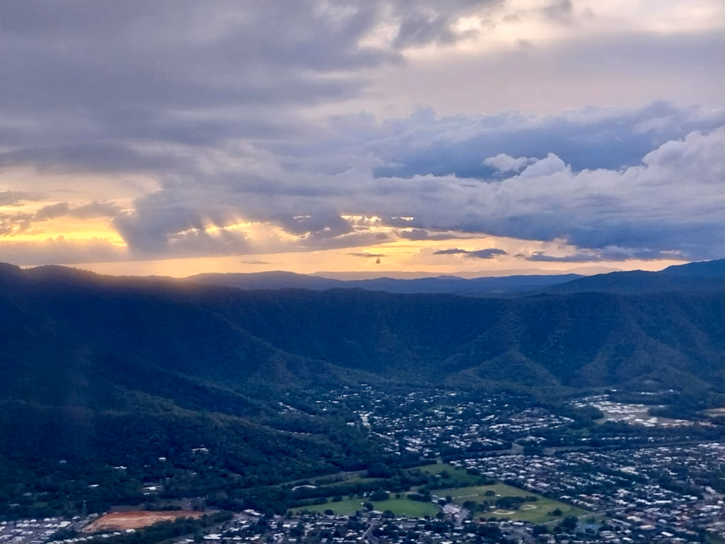 Sunset over the mountains and coastline on final descent into Cairns
