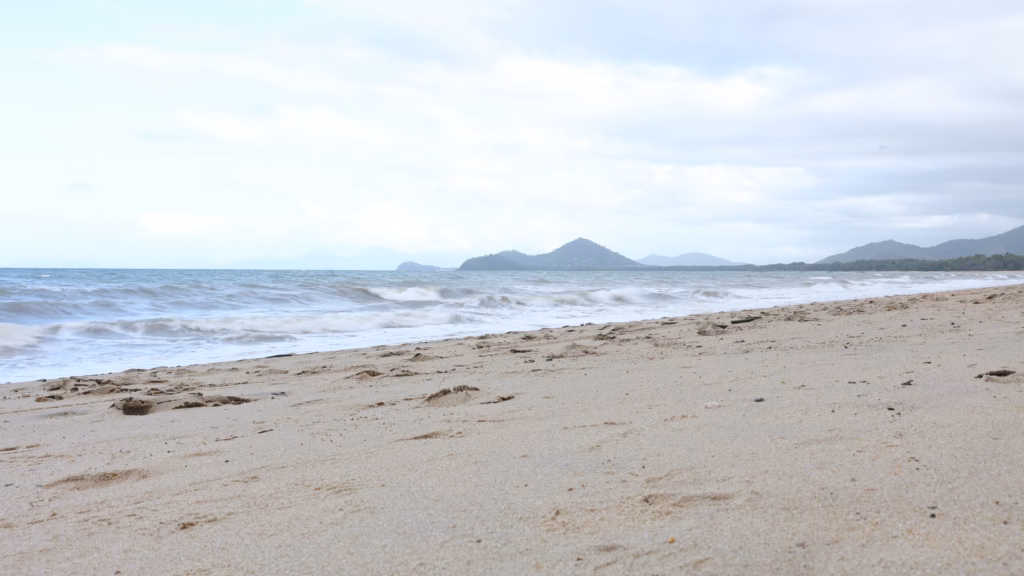 Close-up of sand and breaking waves at Palm Cove Beach