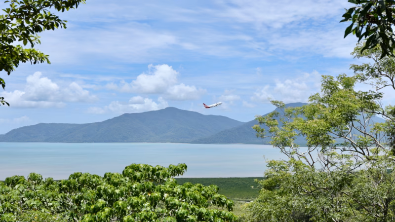 Plane taking off from Cairns Airport, seen from the lookout