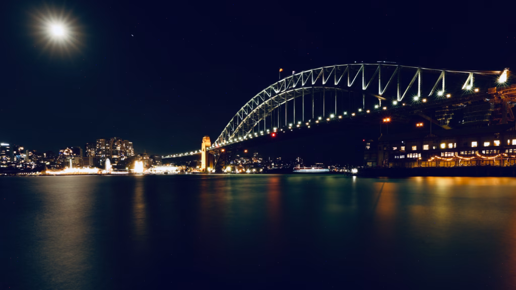 Sydney Harbour Bridge at night under a full moon, seen from near Pier One Sydney Harbour