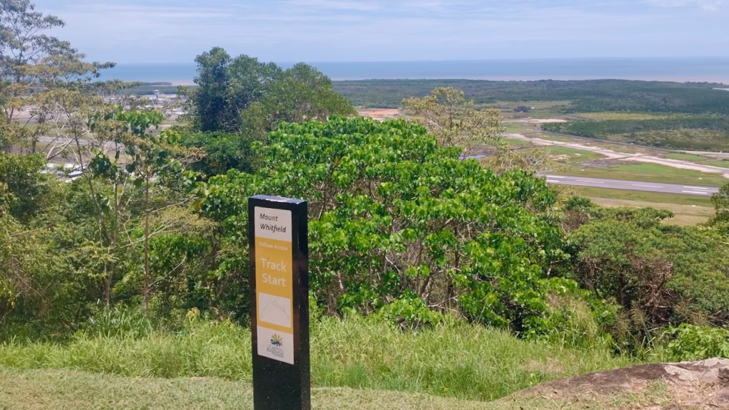 Yellow Arrow Track start sign with airport view below
