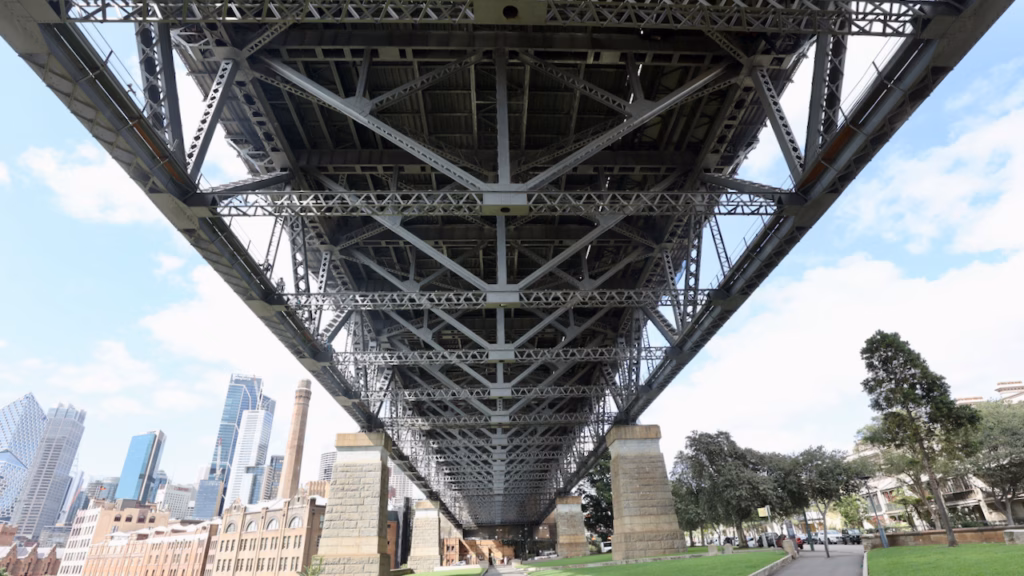 Standing directly beneath the Sydney Harbour Bridge's southern approach steelwork at Dawes Point, looking straight up
