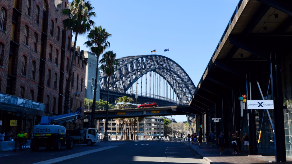 Heritage ASN Co. Building on Hickson Road with the Sydney Harbour Bridge framed at the end of the street, cruise terminal signage visible