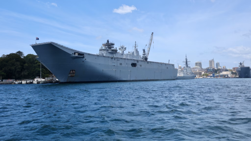 Navy amphibious assault ship HMAS Adelaide (L01) moored at Garden Island naval base, seen from a Sydney ferry
