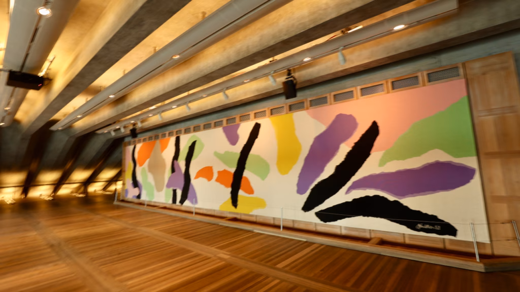Interior of the Utzon Room inside the Sydney Opera House, the large abstract tapestry Homage to Carl Philipp Emanuel Bach on the west wall, polished wood floor, concrete beam ceiling