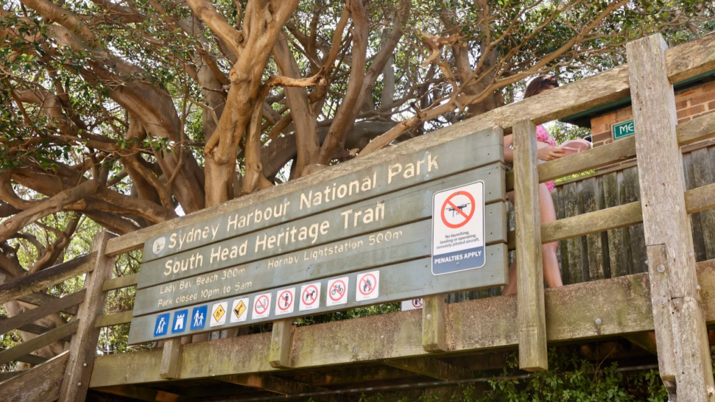 South Head Heritage Trail entrance sign in Sydney Harbour National Park showing distances to Lady Bay Beach and Hornby Lightstation