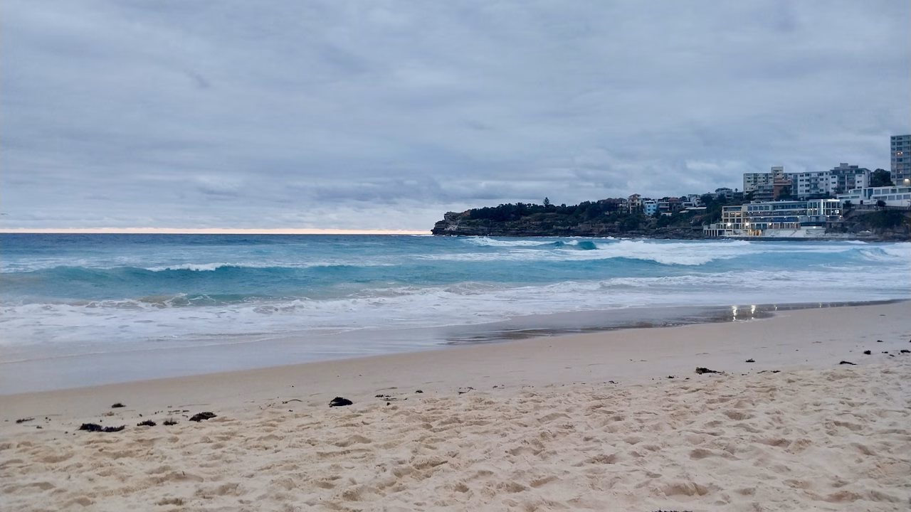 Bondi Beach at dusk with the Bondi Icebergs building lit up